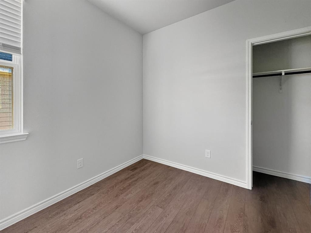 9944 Dynamic Drive Fort Worth, TX 76131 - Photo 13 of 17 a view of an empty room with wooden floor and a window