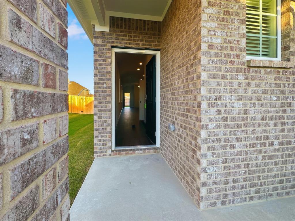 9944 Dynamic Drive Fort Worth, TX 76131 - Photo 2 of 17 a view of a brick house with a large door