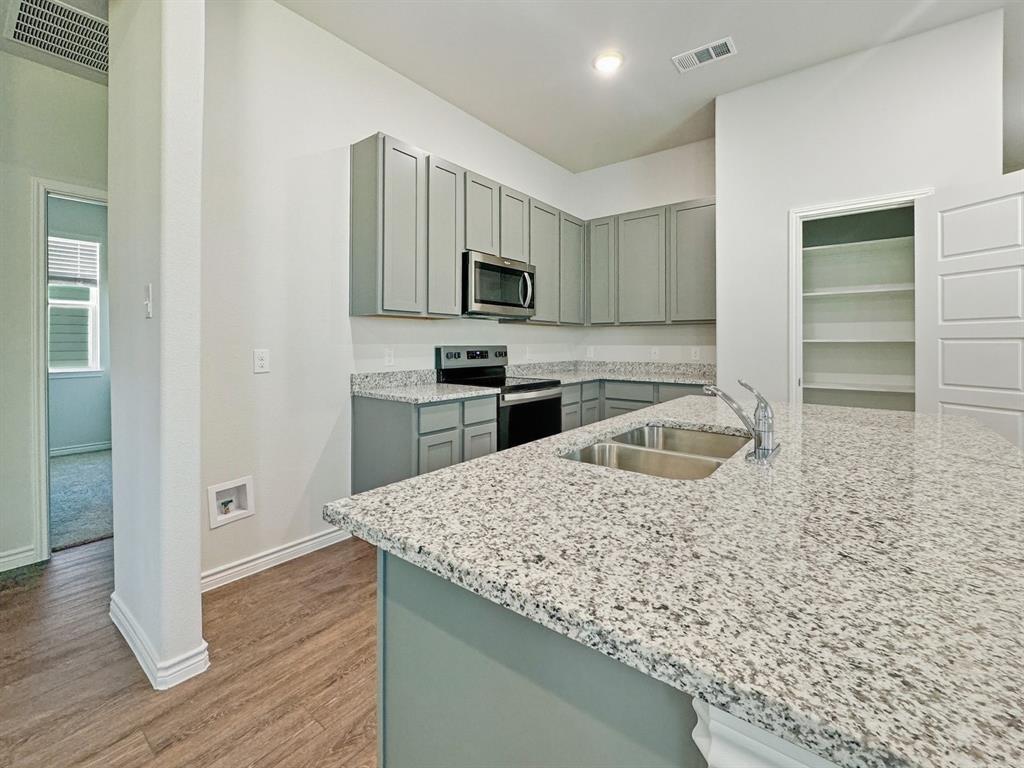 9944 Dynamic Drive Fort Worth, TX 76131 - Photo 6 of 17 a kitchen with stainless steel appliances granite countertop a sink stove and refrigerator