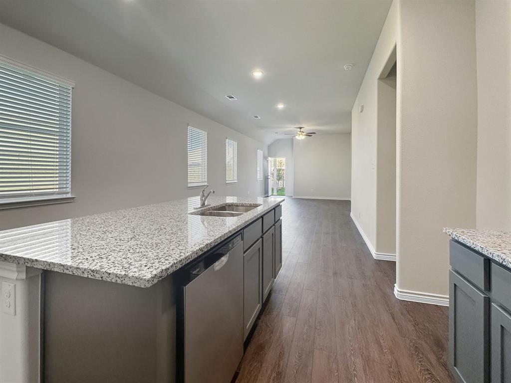 9944 Dynamic Drive Fort Worth, TX 76131 - Photo 8 of 17 a kitchen with granite countertop kitchen island wooden floors granite counter tops and a sink