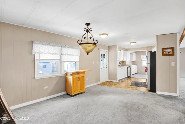 a kitchen with a refrigerator sink stove and cabinets