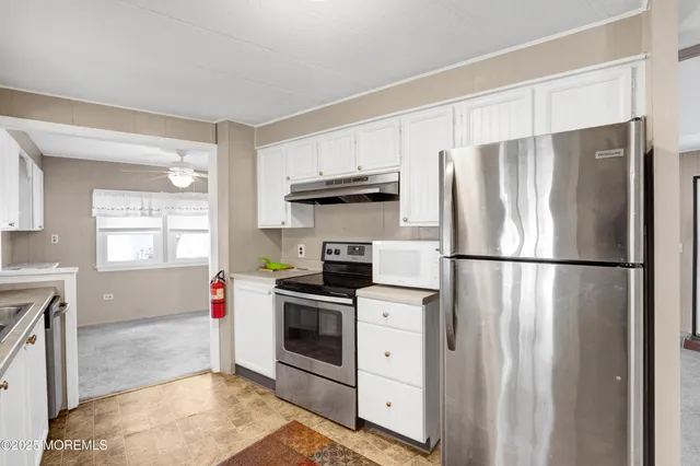 a kitchen with a sink appliances and cabinets