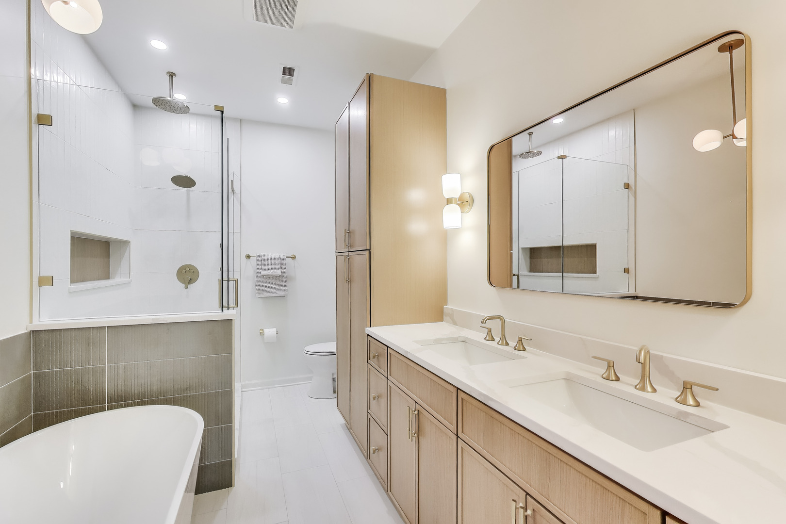 1034 West Monroe Street Chicago, IL 60607 - Photo 11 of 26 a bathroom with a double vanity sink a toilet a mirror and shower