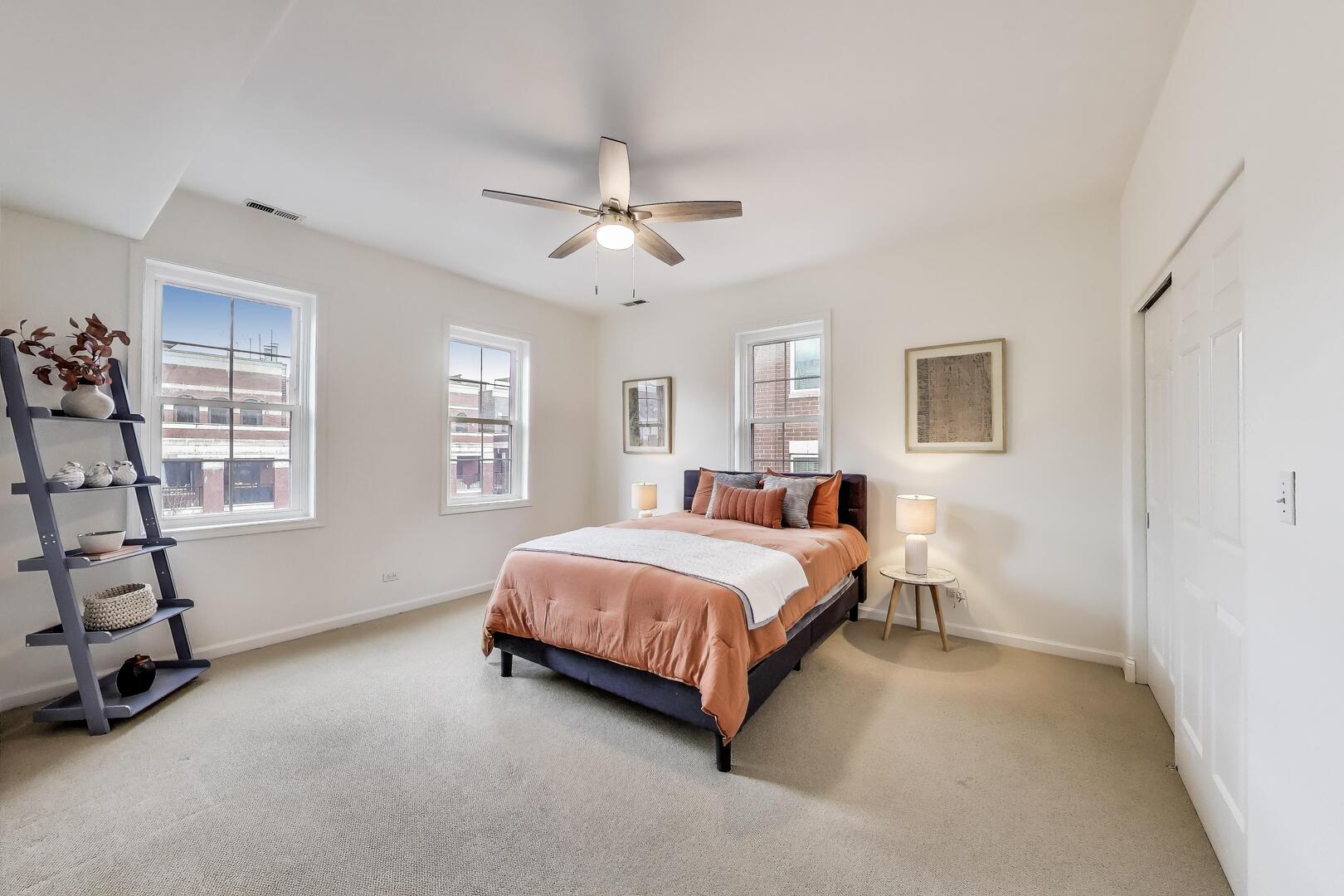 1034 West Monroe Street Chicago, IL 60607 - Photo 17 of 26 a spacious bedroom with a bed and a window