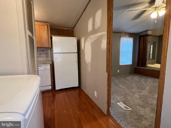 a view of kitchen with a refrigerator and wooden floor