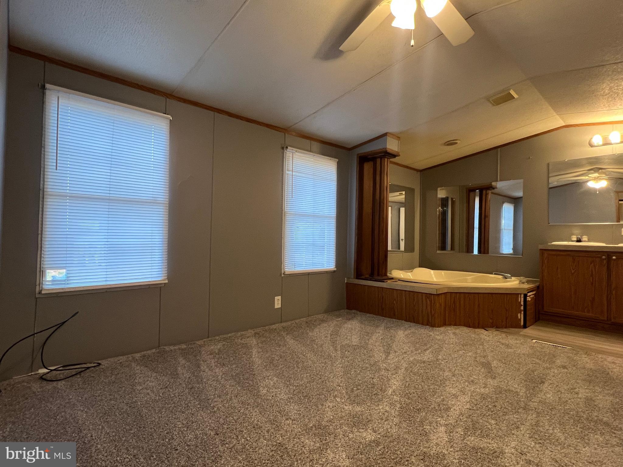 4328 Ridge Road, Unit 14 Mount Airy, MD 21771 - Photo 18 of 42 a spacious bedroom with a large bed and a chandelier