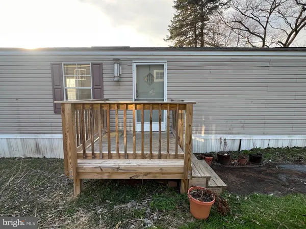 a view of a wooden deck and a backyard