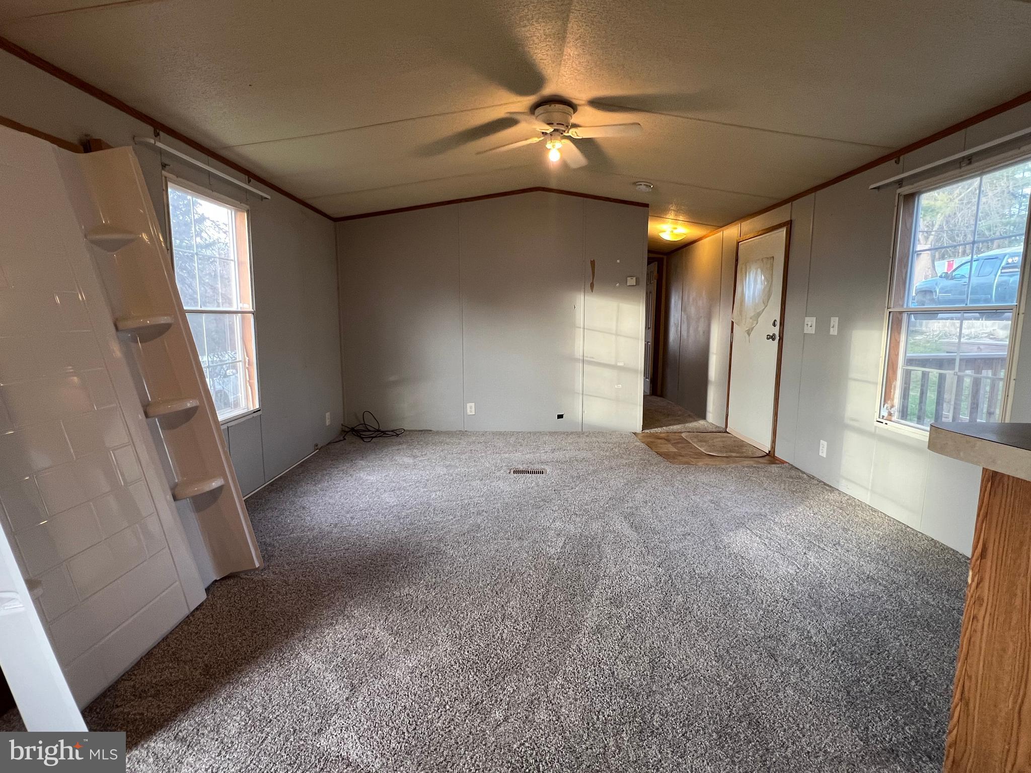 4328 Ridge Road, Unit 14 Mount Airy, MD 21771 - Photo 25 of 42 en empty room with windows and ceiling fan