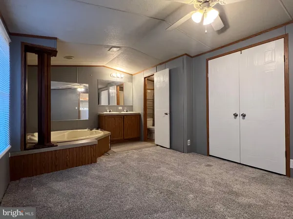 a bathroom with a granite countertop sink mirror and bathtub