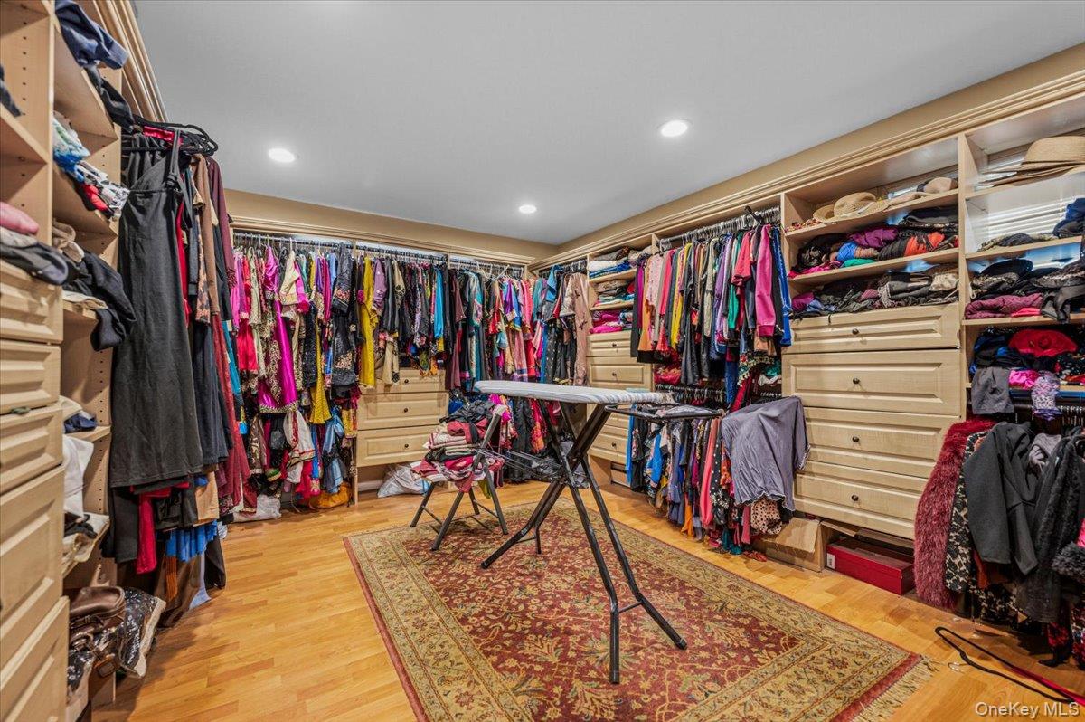626 Caledonia Road Dix Hills, NY 11746 - Photo 34 of 49 a view of walk in closet with clothes
