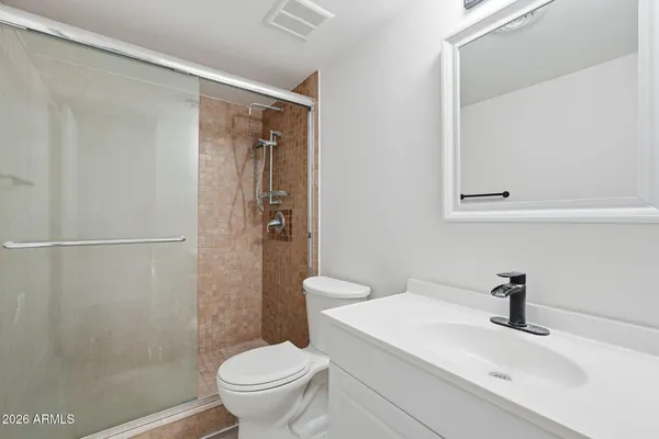 a white toilet sitting next to a bathroom sink