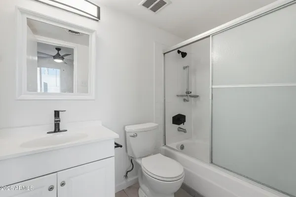 a bathroom with a toilet sink shower and mirror