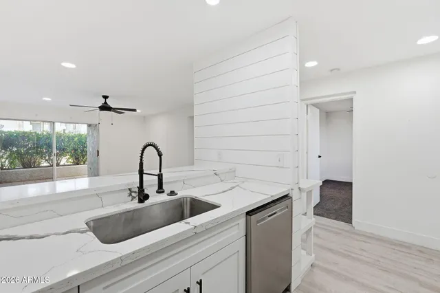 a kitchen with a sink and a hard wood floor