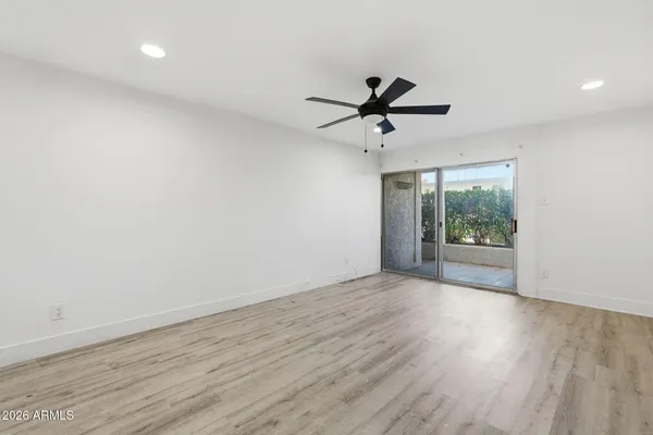 a view of room with wooden floor and windows