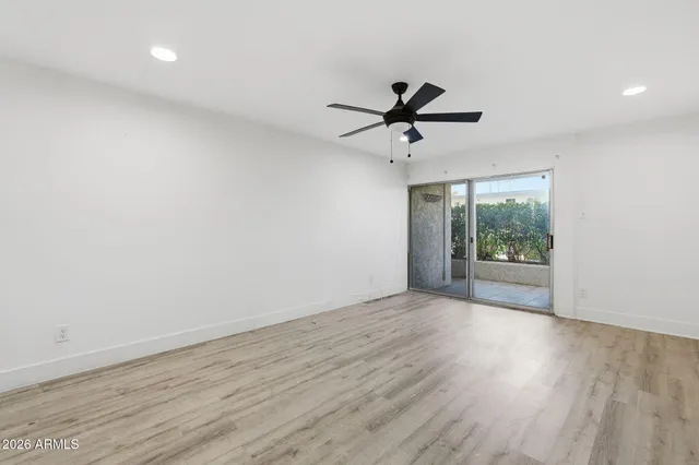 a view of room with wooden floor and windows