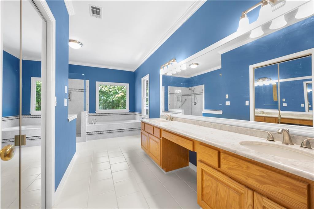 3334 Trails End Road Northeast Roswell, GA 30075 - Photo 29 of 54 a spacious bathroom with a granite countertop sink and a large mirror