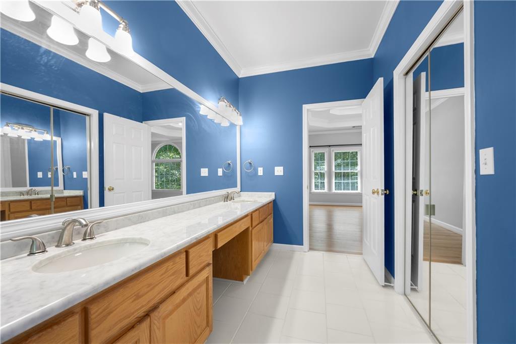 3334 Trails End Road Northeast Roswell, GA 30075 - Photo 31 of 54 a spacious bathroom with a granite countertop sink and a large mirror