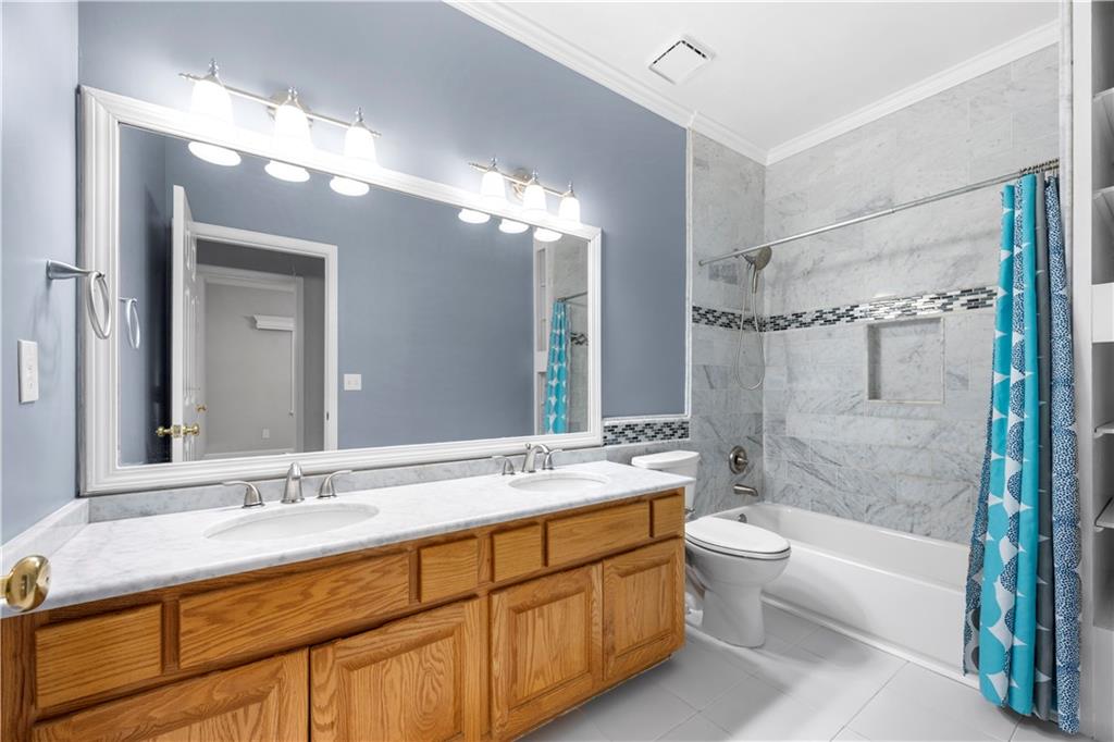 3334 Trails End Road Northeast Roswell, GA 30075 - Photo 35 of 54 a bathroom with a double vanity sink toilet mirror and bathtub