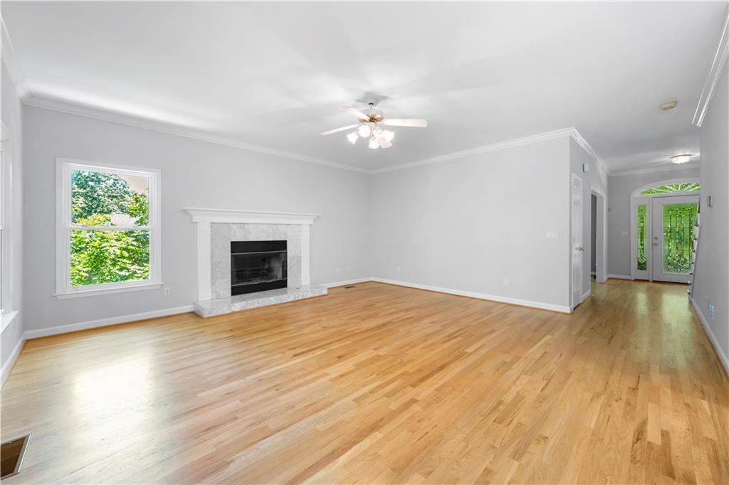 3334 Trails End Road Northeast Roswell, GA 30075 - Photo 9 of 54 a view of empty room with wooden floor and fan
