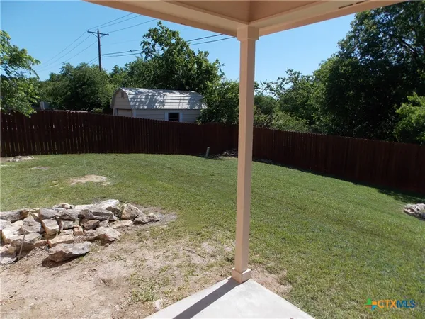 a view of a backyard of the house