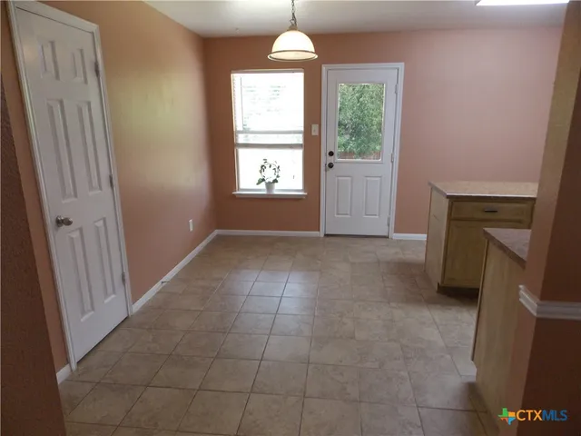 a bedroom with bed and window