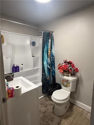 a bathroom with a sink mirror vanity and toilet
