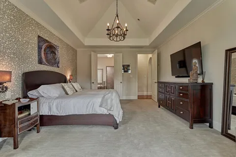 a spacious bathroom with a double vanity sink a toilet a mirror and shower