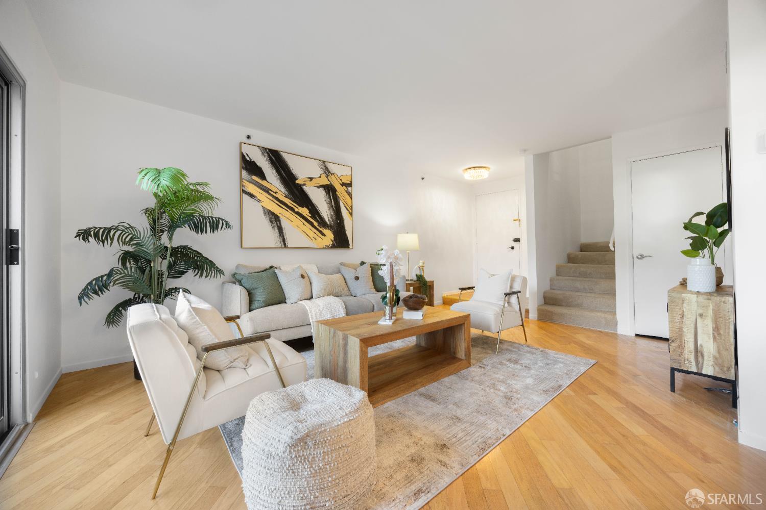 a living room with furniture floor to ceiling window and potted plant