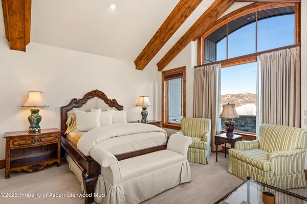 a bedroom with a bed and a couch