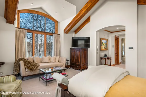 a bedroom with furniture and a flat screen tv
