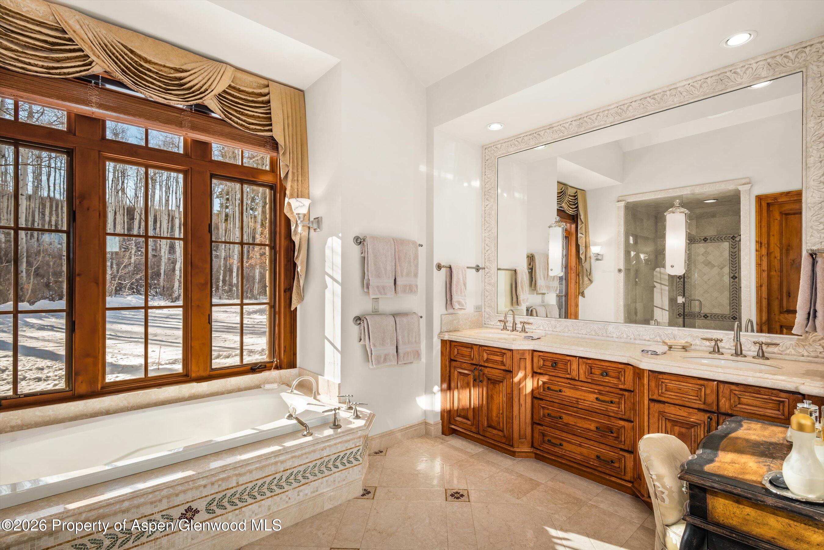 971 Cluny Road Aspen, CO 81611 - Photo 20 of 39 a spacious bathroom with a tub sink and mirror