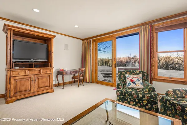 a living room with furniture and a flat screen tv