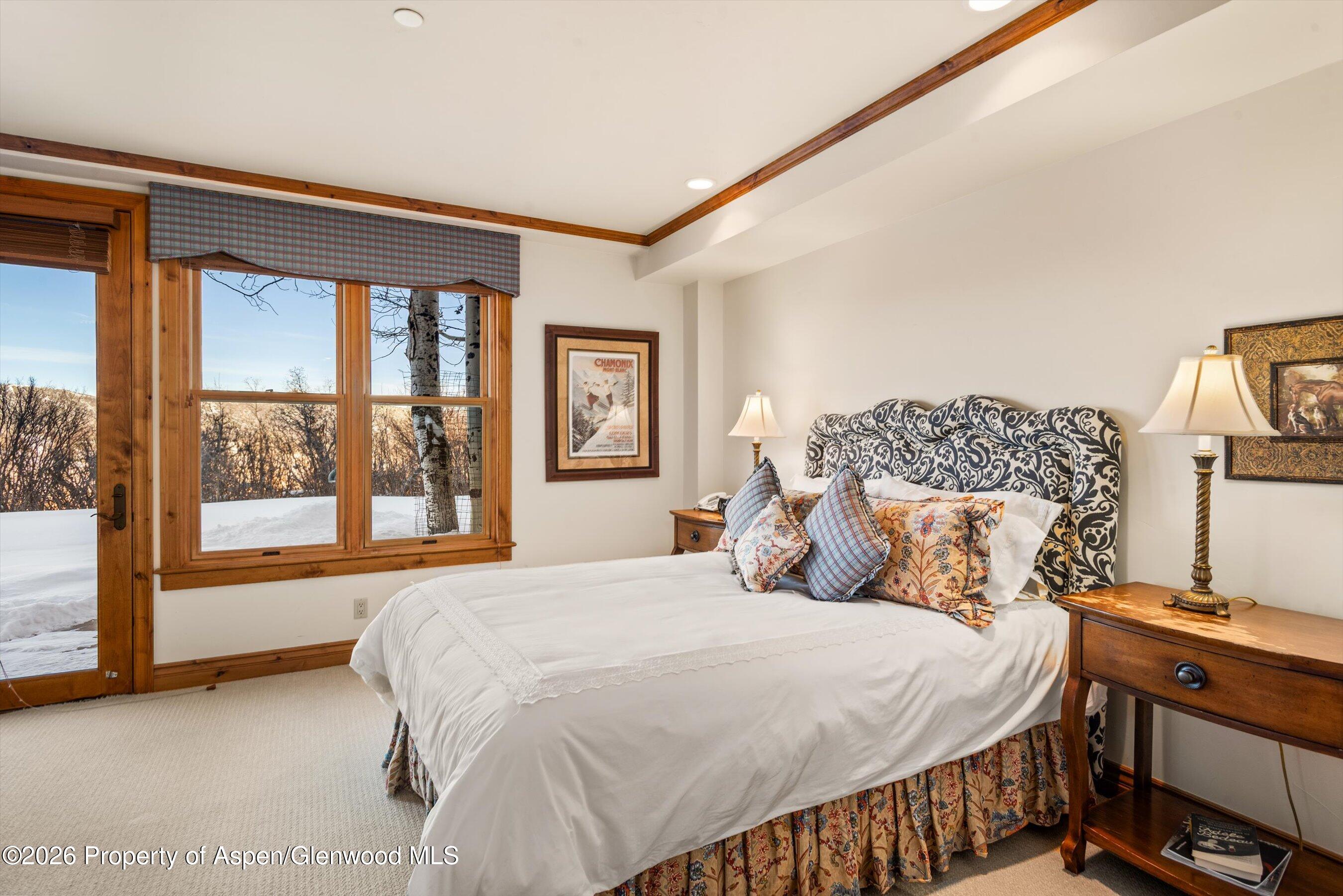 971 Cluny Road Aspen, CO 81611 - Photo 25 of 39 a bedroom with a bed and a large window with outer view