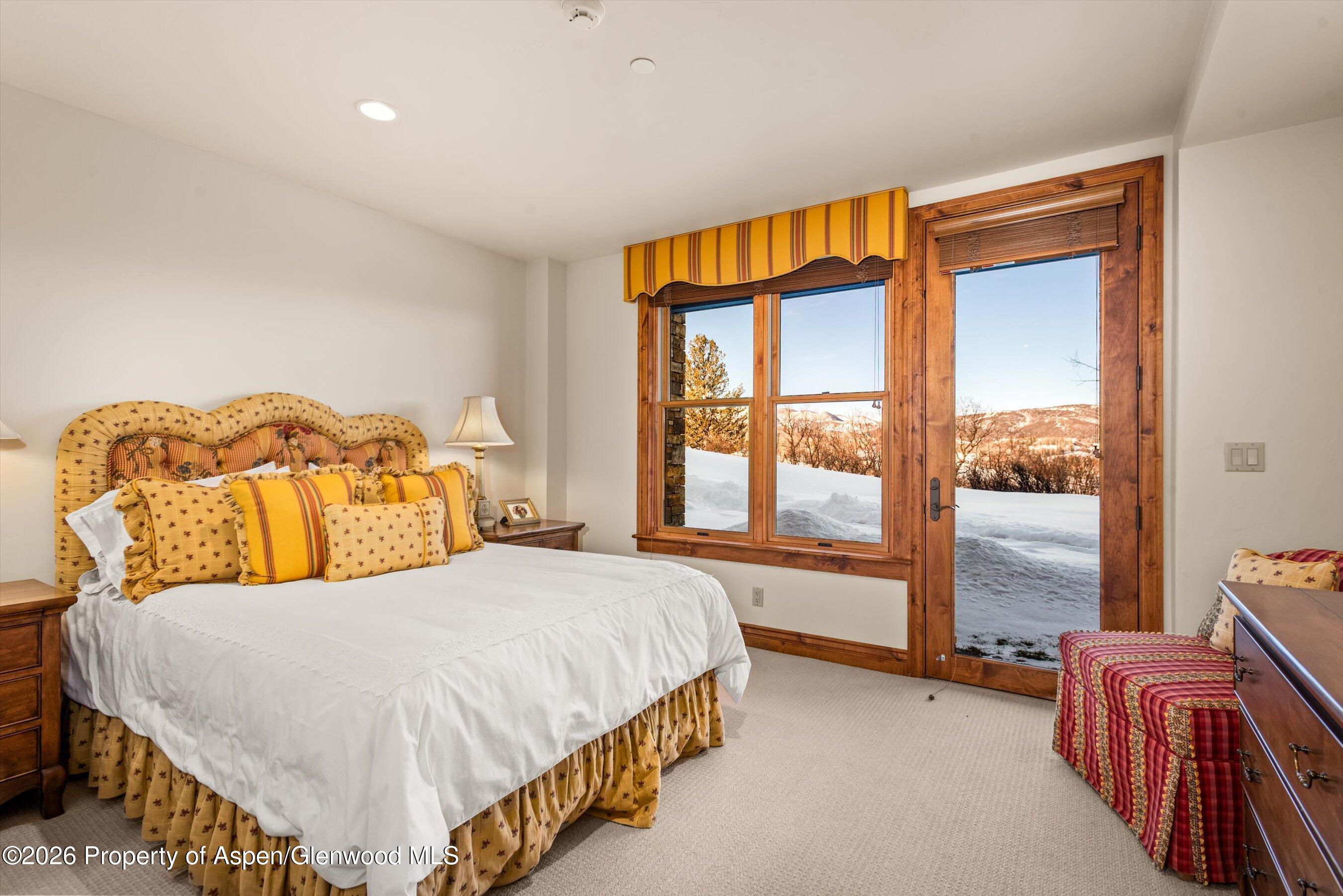 971 Cluny Road Aspen, CO 81611 - Photo 29 of 39 a bedroom with a bed and glass window