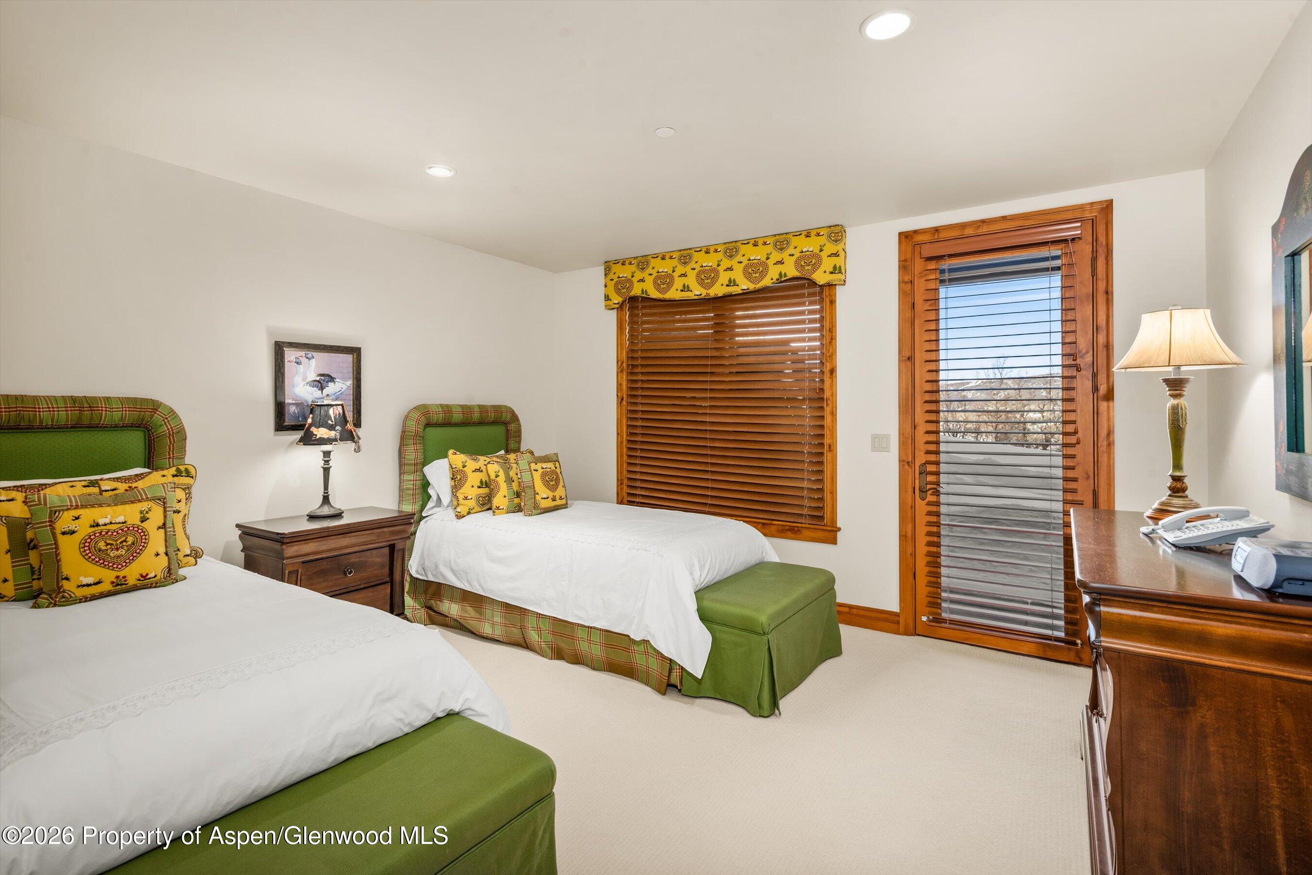 971 Cluny Road Aspen, CO 81611 - Photo 31 of 39 a bedroom with two beds and a window