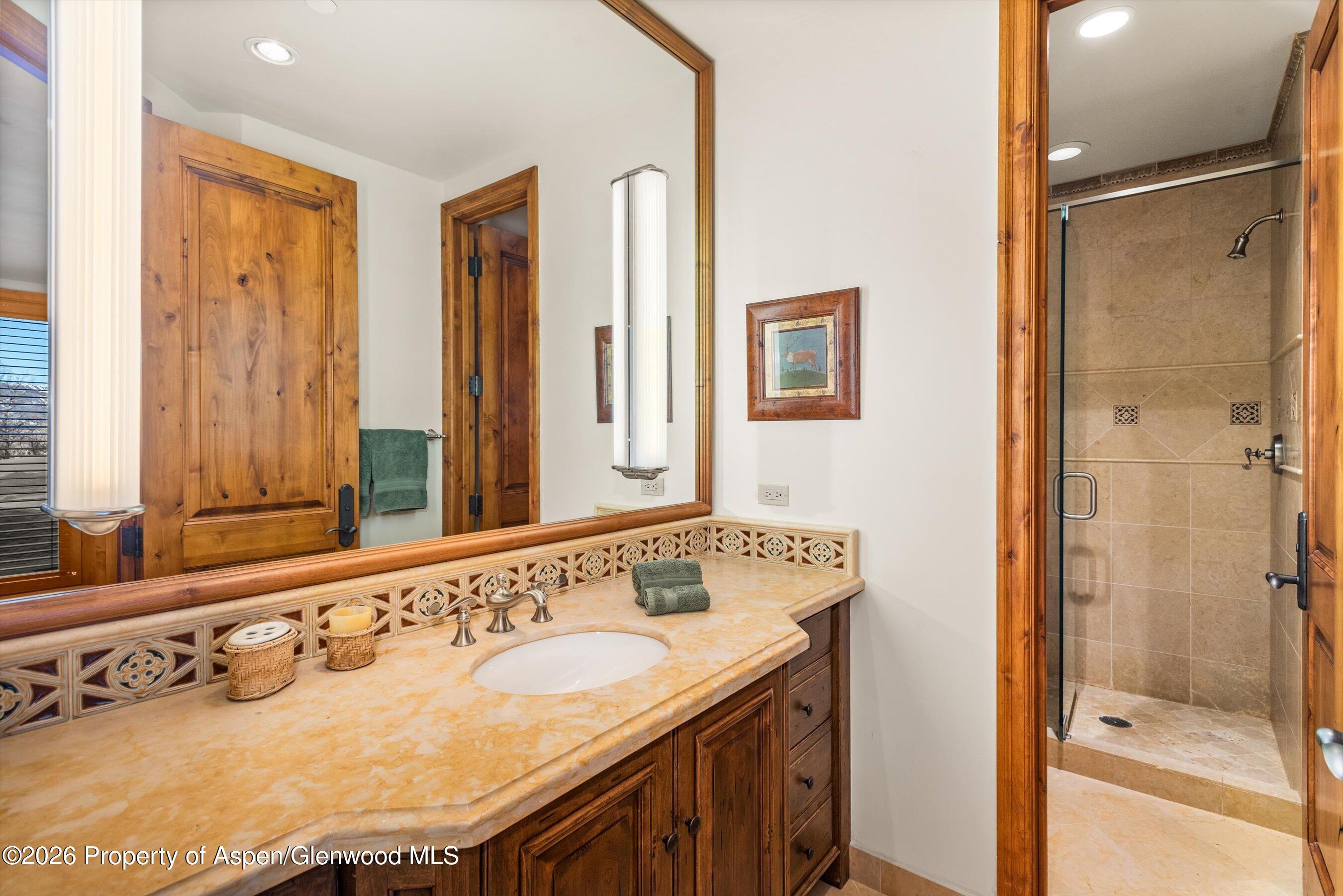 971 Cluny Road Aspen, CO 81611 - Photo 32 of 39 a bathroom with a sink and a mirror