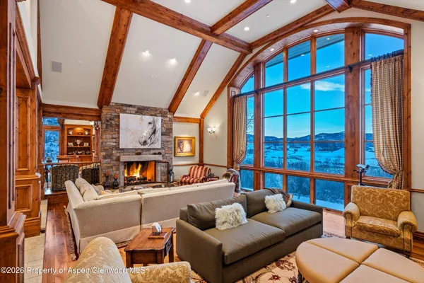 a living room with furniture and a floor to ceiling window