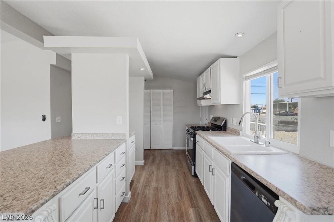 283 Aztec Lane Henderson, NV 89015 - Photo 6 of 21 Gleaming counters and modern appliances define this well-appointed culinary space.