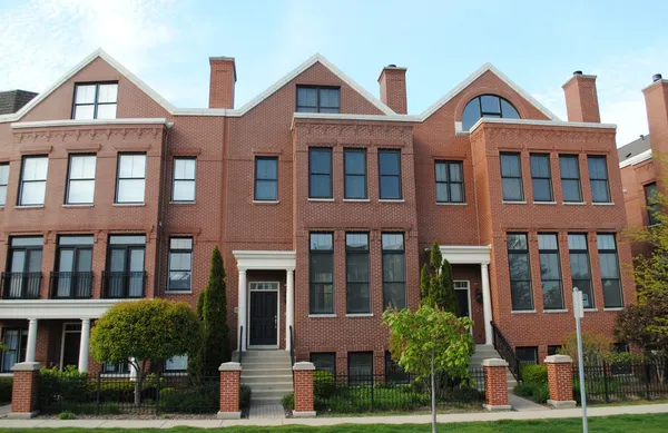 a front view of a residential apartment building with a yard