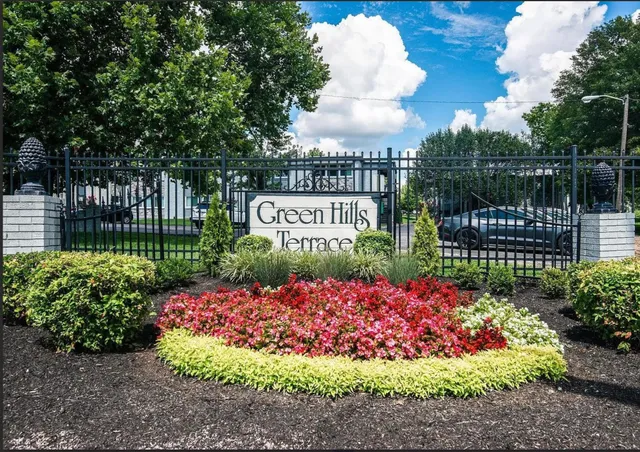 a front view of a house with a yard and tree s