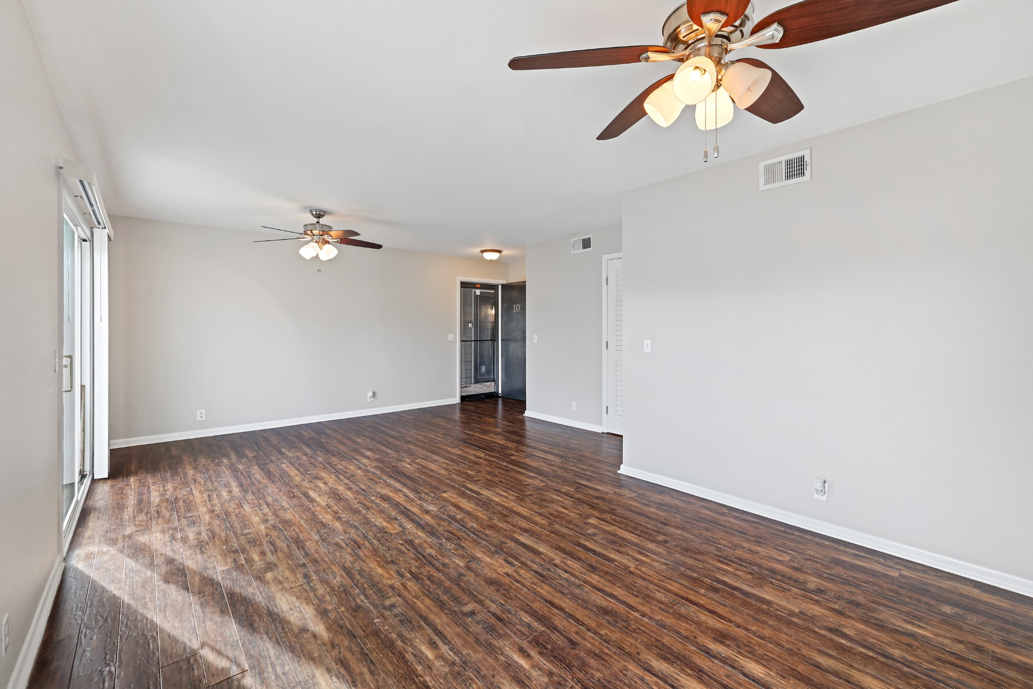 1900 Richard Jones Road, Unit V10 Nashville, TN 37215 - Photo 4 of 49 wooden floor in an empty room with a chandelier fan
