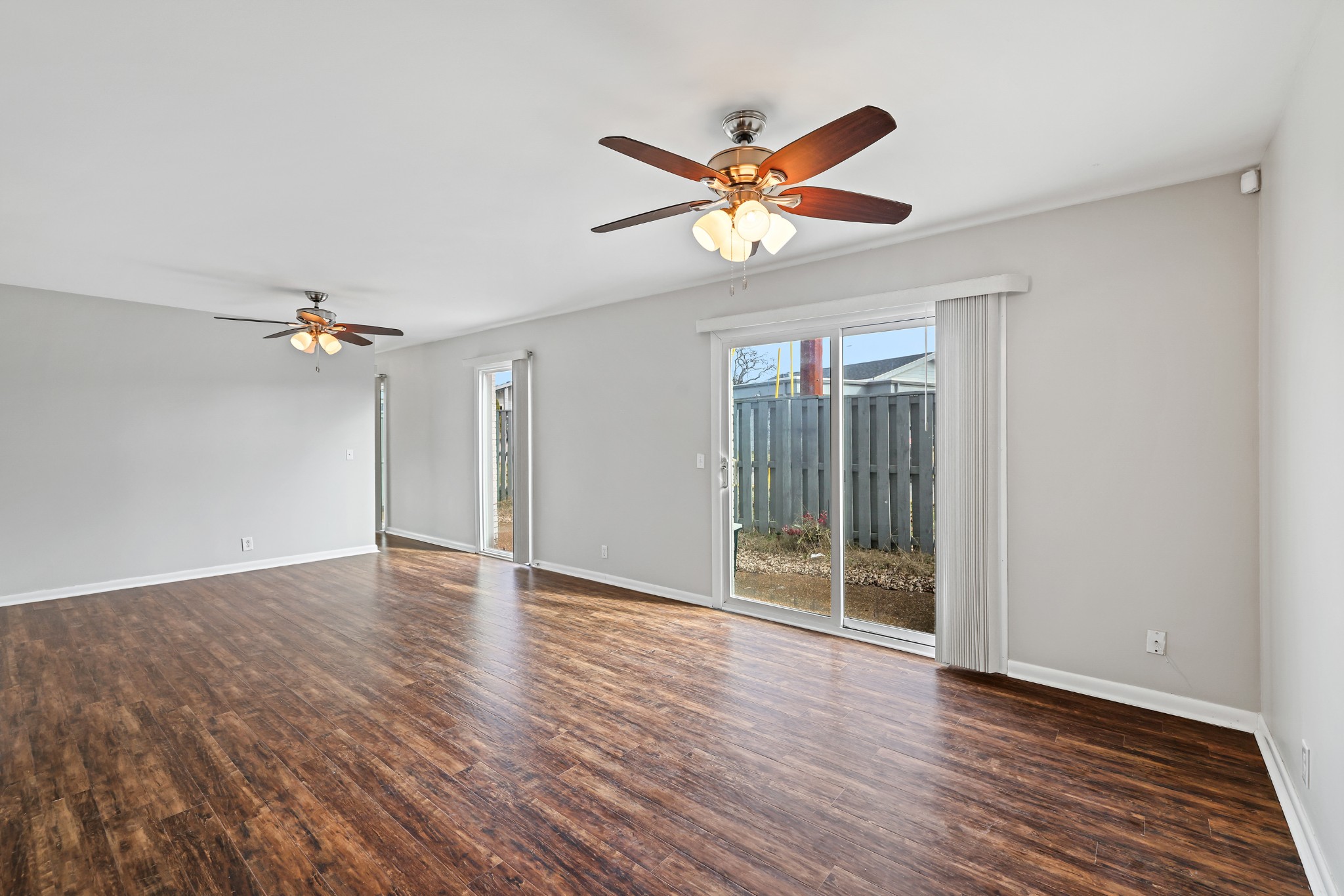 1900 Richard Jones Road, Unit V10 Nashville, TN 37215 - Photo 5 of 49 a view of an empty room with wooden floor and a ceiling fan