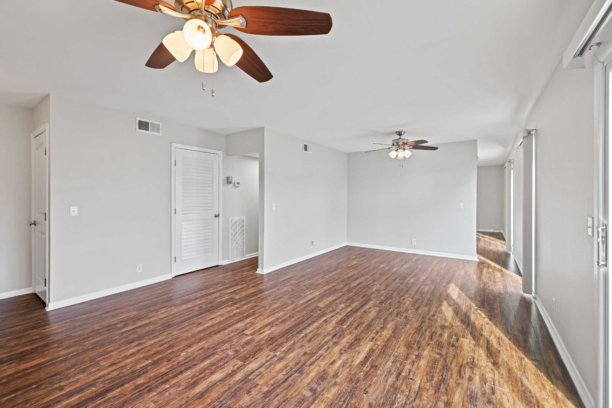1900 Richard Jones Road, Unit V10 Nashville, TN 37215 - Photo 6 of 49 a view of an empty room with wooden floor and a ceiling fan
