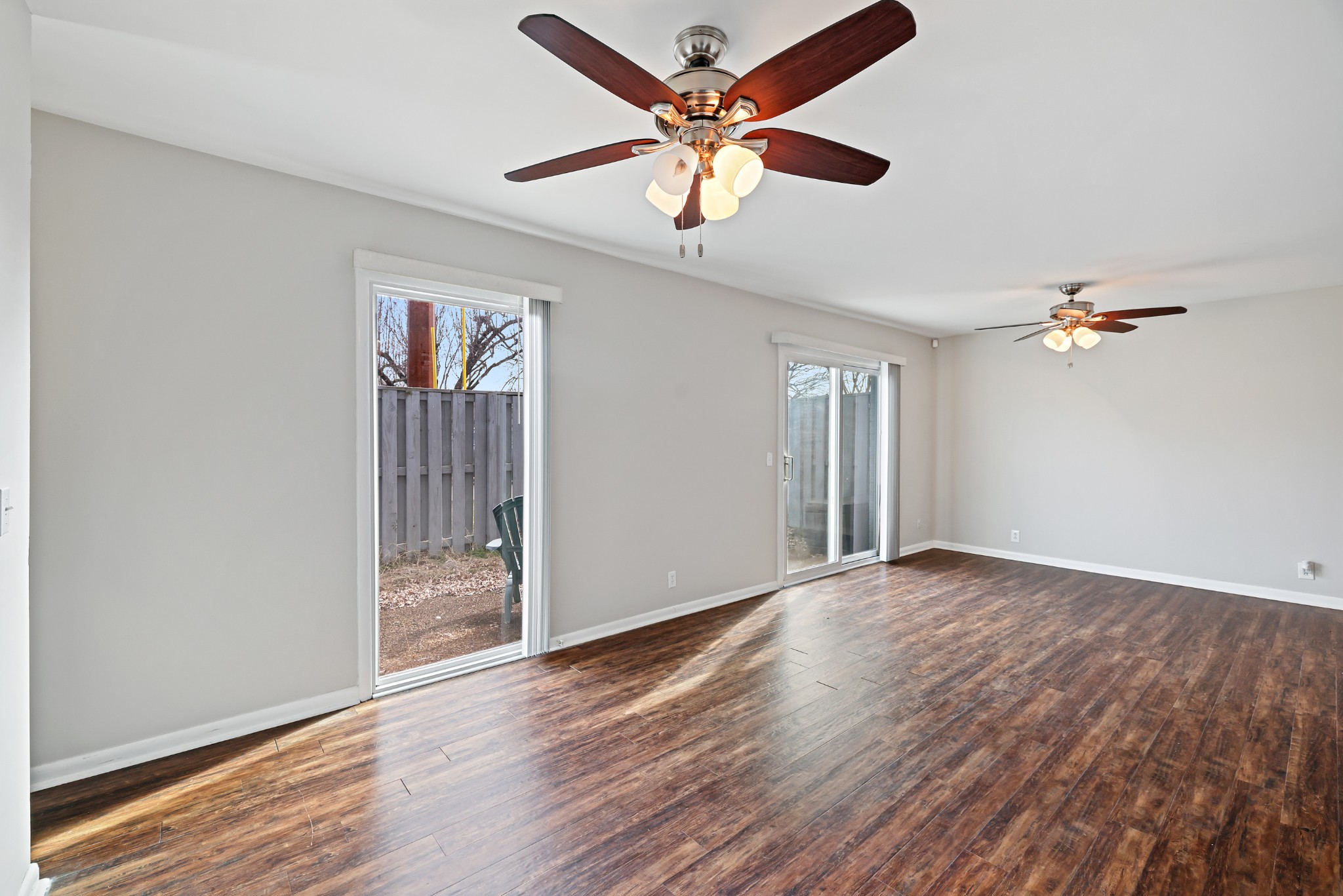 1900 Richard Jones Road, Unit V10 Nashville, TN 37215 - Photo 8 of 49 an empty room with wooden floor chandelier fan and windows