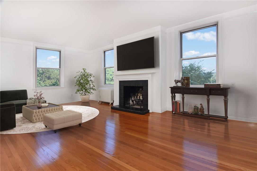 64 Sagamore Road, Unit L8 Bronxville, NY 10708 - Photo 1 of 1 a living room with furniture fireplace and flat screen tv