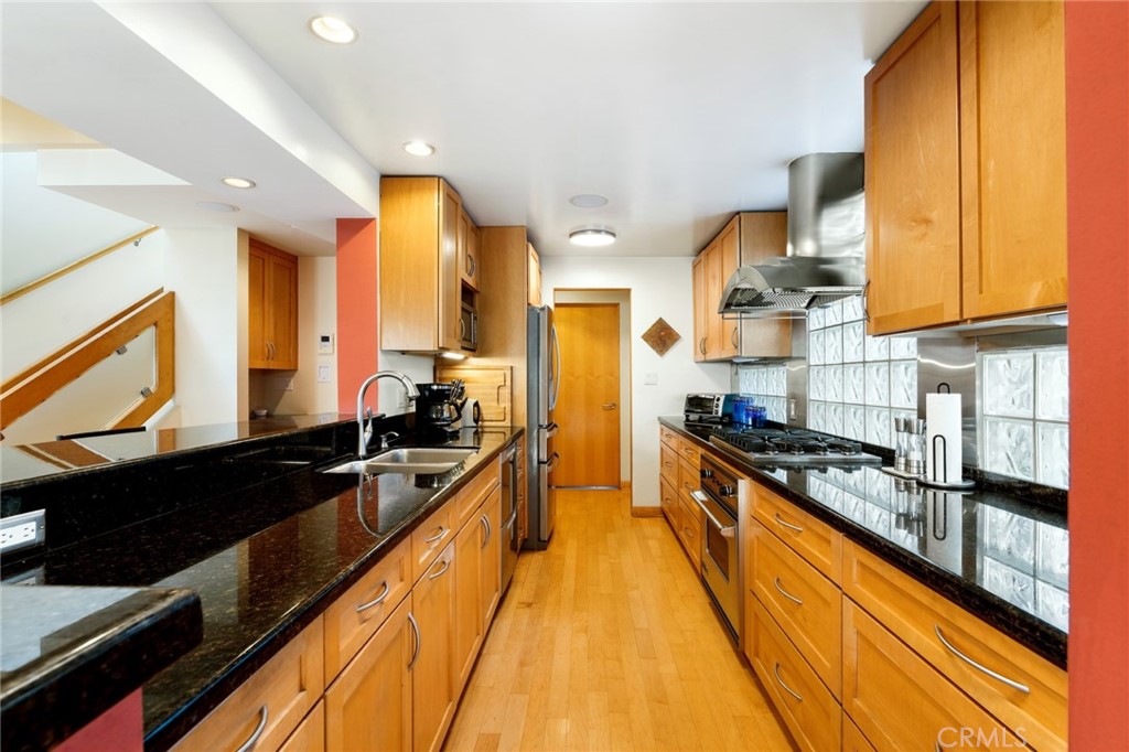 253 Ancona Drive Long Beach, CA 90803 - Photo 18 of 39 a large kitchen with stainless steel appliances granite countertop a stove and a sink