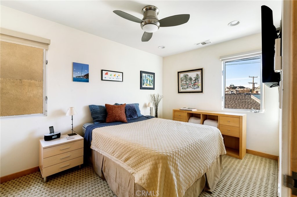 253 Ancona Drive Long Beach, CA 90803 - Photo 21 of 39 a bedroom with a bed and a chandelier