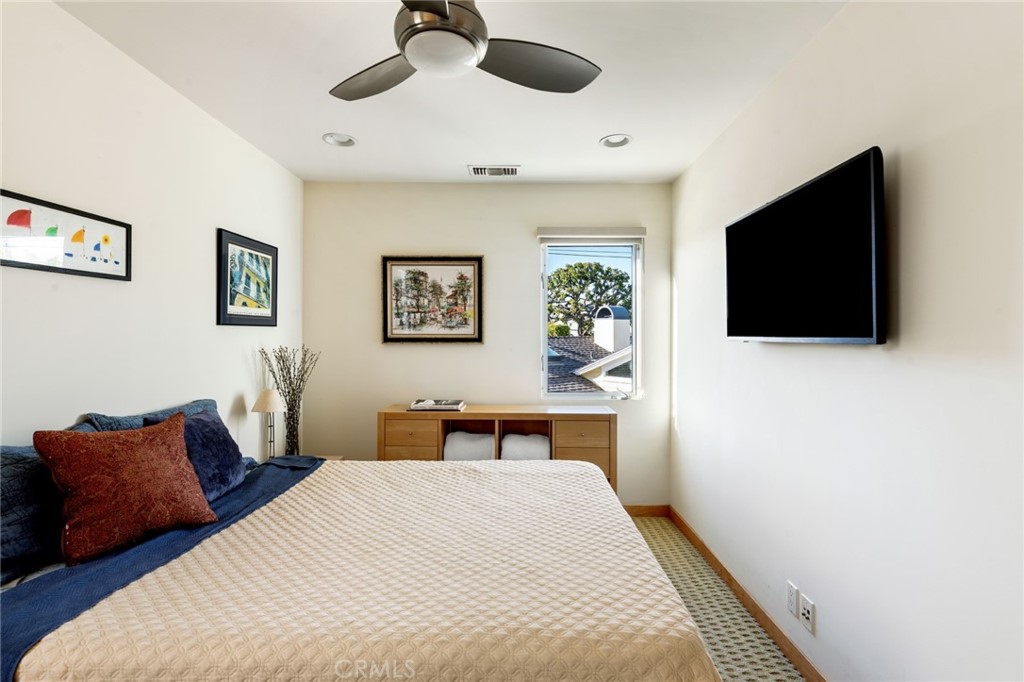 253 Ancona Drive Long Beach, CA 90803 - Photo 22 of 39 a bedroom with a bed a window and a flat screen tv