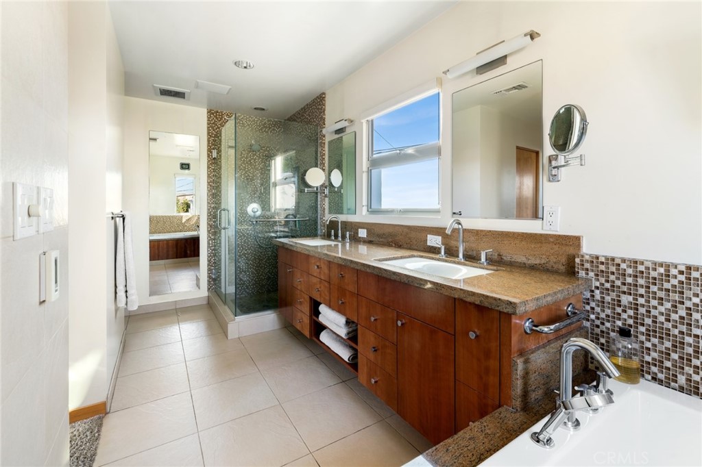 253 Ancona Drive Long Beach, CA 90803 - Photo 33 of 39 a spacious bathroom with a double vanity sink a mirror and a shower