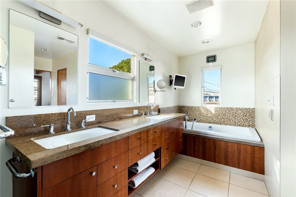 253 Ancona Drive Long Beach, CA 90803 - Photo 34 of 39 a bathroom with a granite countertop sink and a mirror